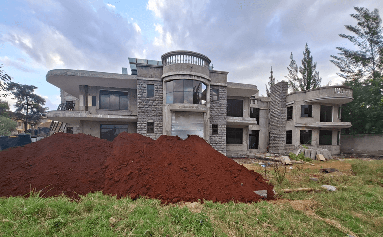 Karen residence under construction — stone cladding and glazed facade